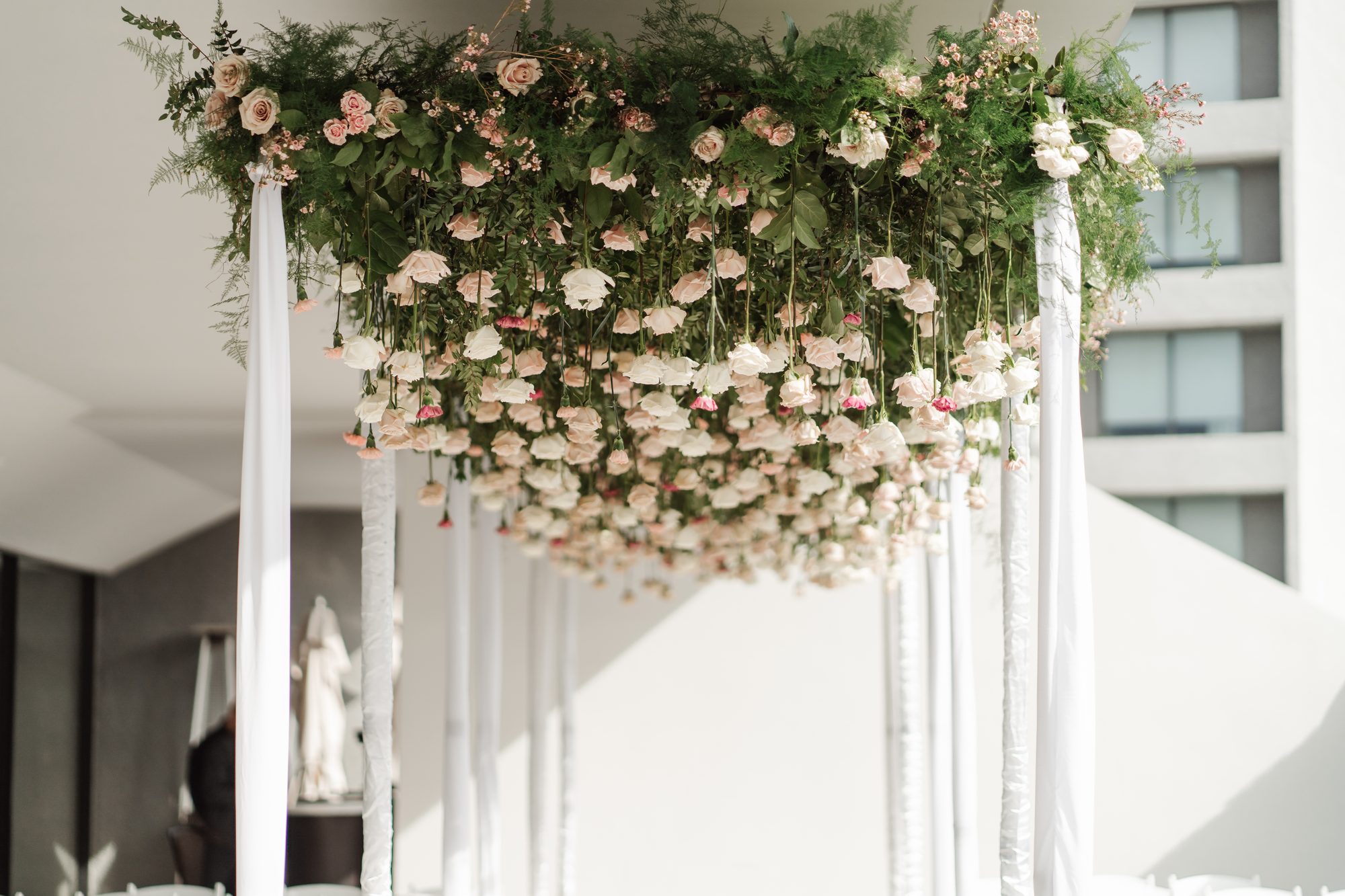 Hanging floral installation of roses and greenery