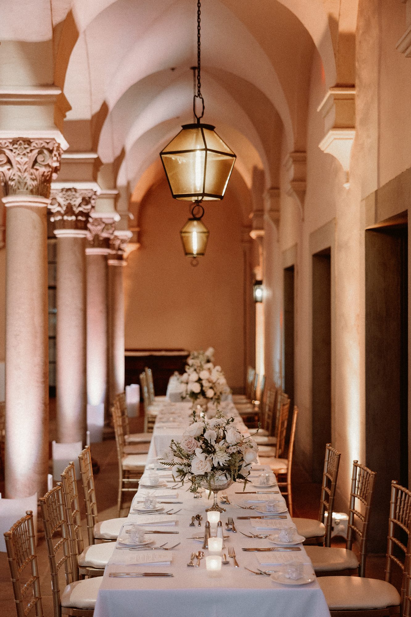 Arched colonnade long table with floral runner